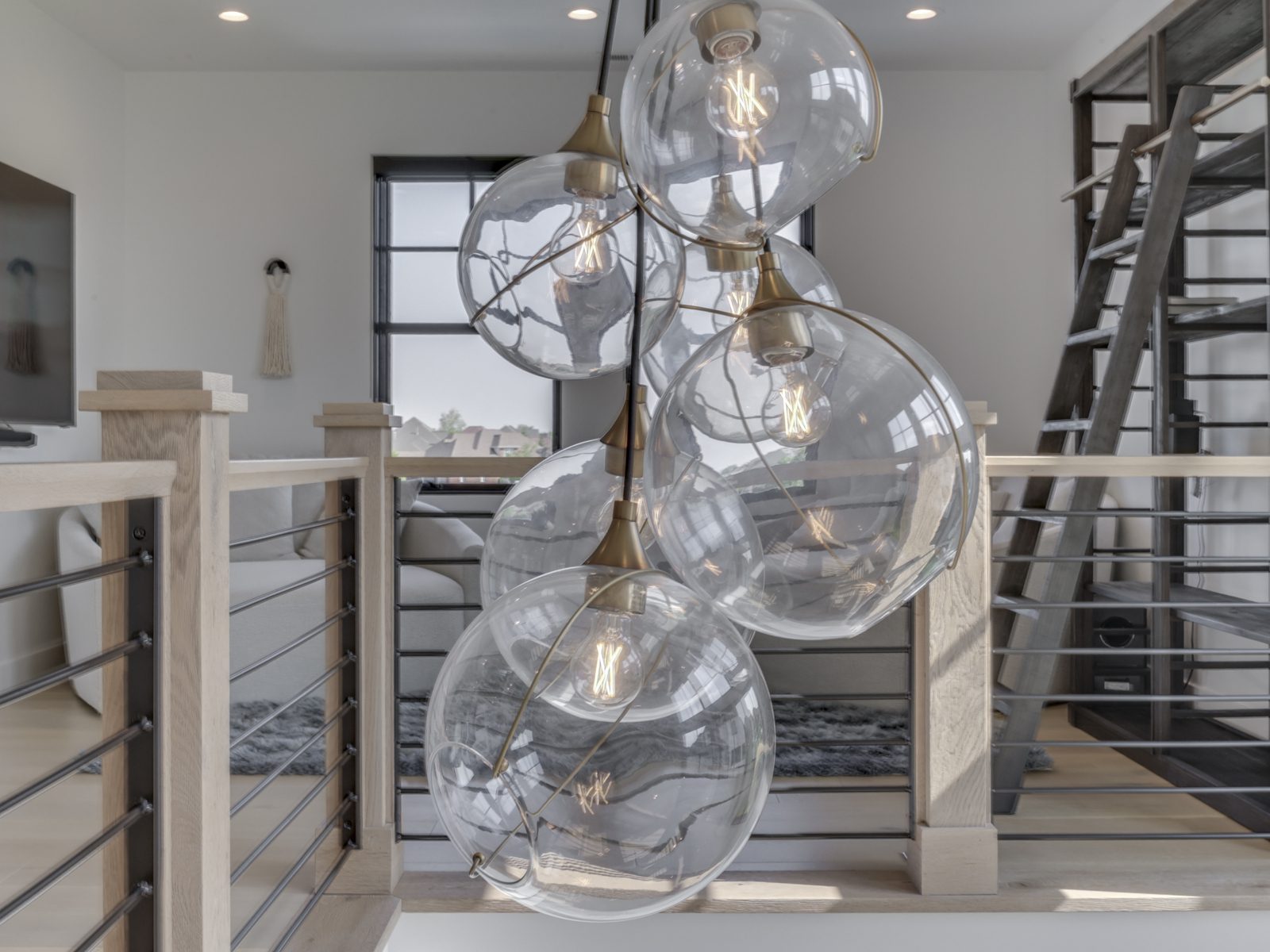 A glass chandelier elegantly hangs from the ceiling, illuminating the room with its sparkling design.